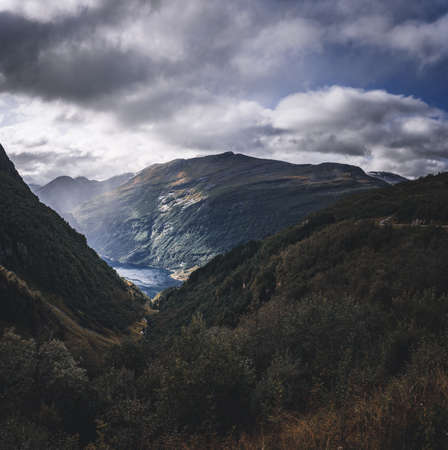 Big Norwegian fjord seen on a dark summer day with rain in the airの写真素材