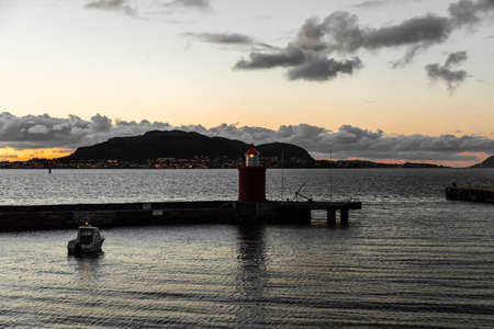 Lighthouse at the inlet to Ãlesund at sunset on a fall evening, Norwayの写真素材