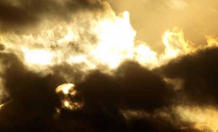 sun behind clauds in a stormの写真素材