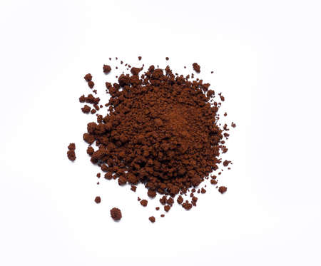 Top view of circle dark coffee powder pile on white backgroundの写真素材