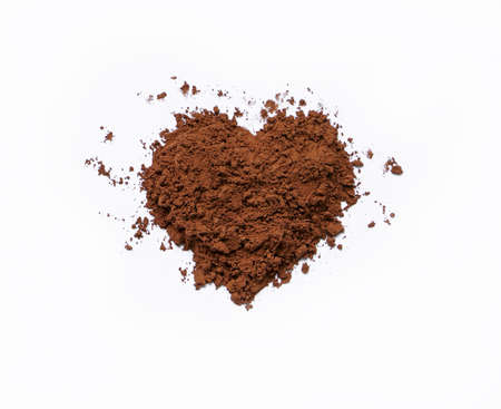 Heart shape cocoa powder on white backgroundの写真素材