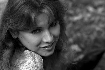 Nice curly girl smiling in the sunlightの写真素材