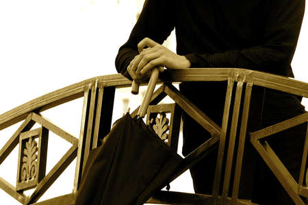 Someone staying with umbrella on the bridgeの写真素材