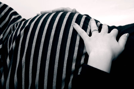 Pretty tummy of a pregnant woman in black and white