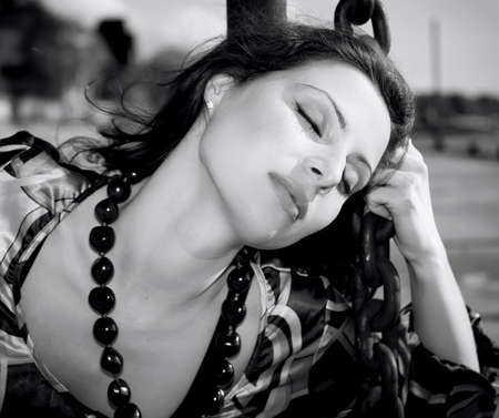 Woman shackled in chains outdoor in monochromeの写真素材