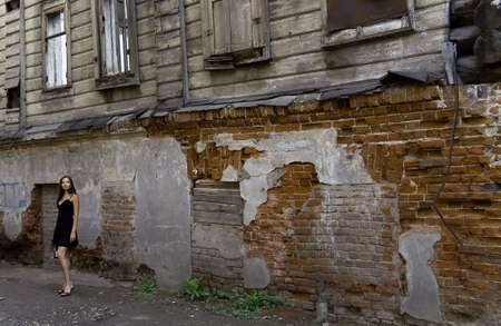 Young woman near the old ruined house in a dressの写真素材
