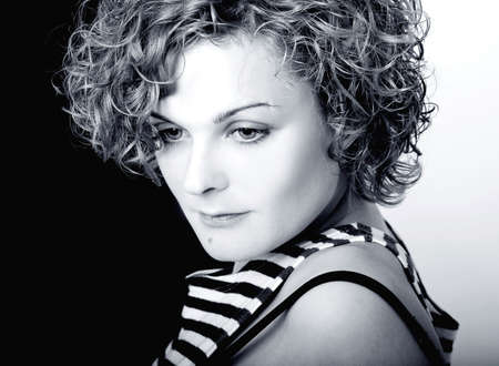 Curly-haired girl in a stripped top in retro styleの写真素材