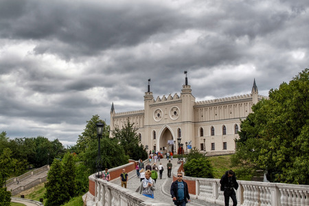 Castle in Lublin Old Town against cloudy sky with tourists walking around, Lublin Polandのeditorial素材