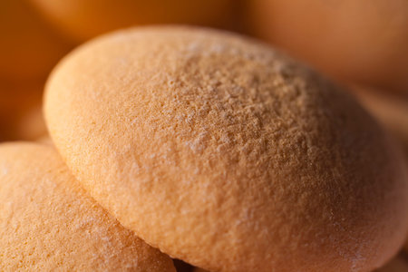 Macro close-up of sponge biscuit with other biscuits in background