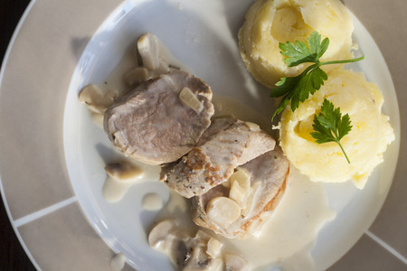Roasted pork tenderloins with champignon mushroom gravy and potato pureeの写真素材