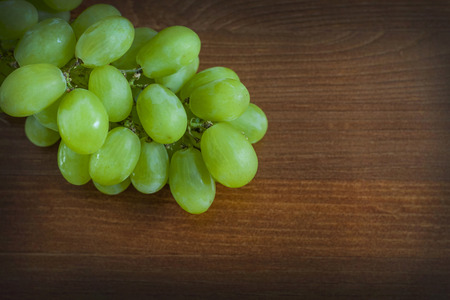 Green grape bunch on tableの写真素材