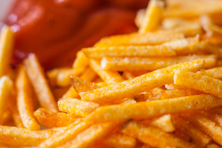 Closeup of french fries corn snacks sticks with ketchup