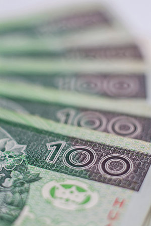 Macro closeup of number 100 on one hundred zloty polish banknotes arrenged in row