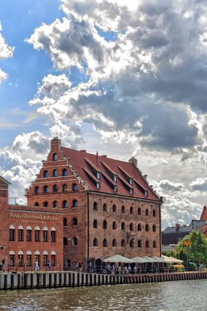 Brick building of Royal Granary in Gdansk on riverside of Motlawa River against cloudy sky, today Royal Hotelのeditorial素材