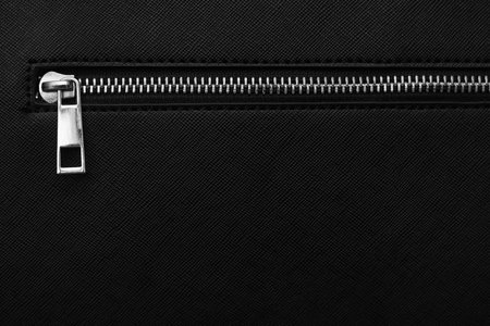 Zip fastener on black women's handbag with copy space