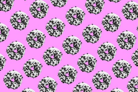 Pattern made with black and white cookie donut on pink background の写真素材