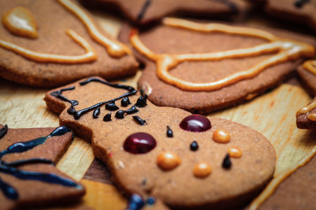 Closeup on children hand decorated christmas gingerbread cookie snowman figurine