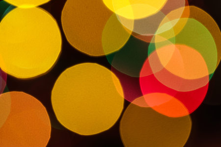Abstract bokeh christmas lights background with yellow, orange, green and red colors