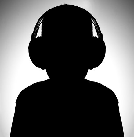 Black and white image silhouette of boy with headphones listening musicの写真素材