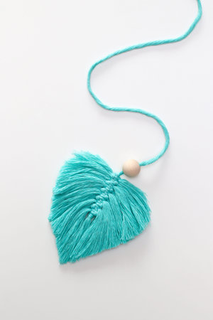 Single macrame hand made leaf with long cord remaining sperm cell