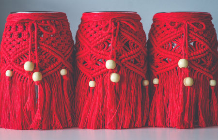 Macrame hand woven with cord red lanterns in a rowの写真素材