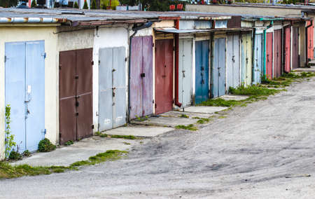 Row of garages for rent with colorful doors painted different paintsの写真素材