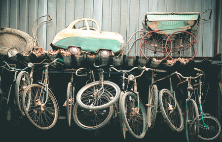 Collection of very old worn out strollers and bicycles