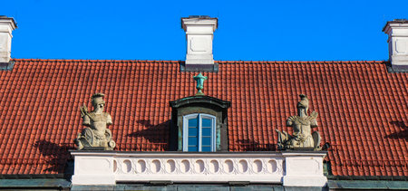 Window and sculptures above entrance to south wing of historic rococo style Branicki Palace in Bialystok, Polandの写真素材