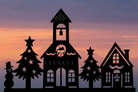 Silhouette of christmas town cut in plywood on sunset sky backgroundの写真素材