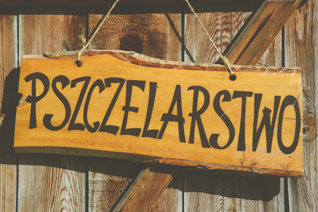 Sign with writing in Polish "beekeeping" on wooden boardの写真素材