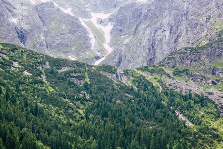 View toward approach to Black Pond Lake in Tatra mountains and Black Pond waterfallの写真素材