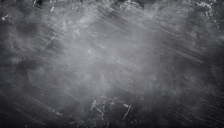 This image showcases an abstract, high-resolution black chalkboard background with subtle scratches and smudges, providing a textured surface ideal for digital or print use in various creative projects.の写真素材