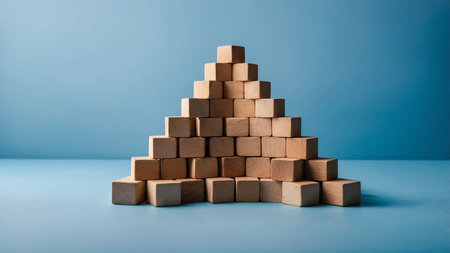 This image displays a minimalist pyramid constructed from wooden blocks, thoughtfully arranged on a...