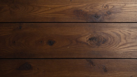 This image displays three horizontally aligned natural wooden planks, showing a warm brown color and...