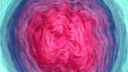 Wool yarn ball showing a gradient from turquoise to pink, creating an abstract design, perfect for backgrounds or texturesの写真素材