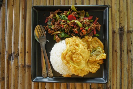 Rice topped with stir-fried pork and basilの写真素材
