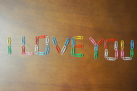 Paperclip with front i love you on wood textureの写真素材