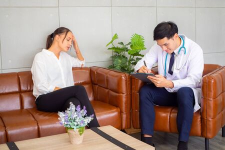 Psychologist metal health concept. Psychologist and depressed patient at office during consultation, The male doctor is treating illness for Asian female patients.の写真素材