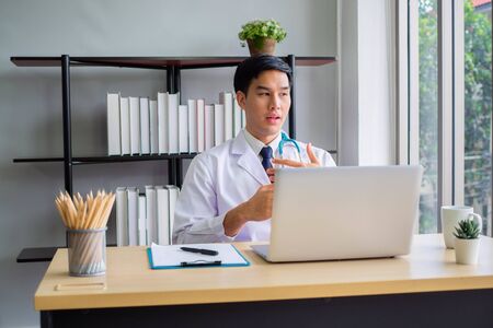 Telemedicine  concept. Doctor working  mobile phone and stethoscope and digital tablet laptop in modern office at hospital. Medical conceptの写真素材