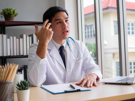 Telemedicine Coronavirus concept. Doctor working with mobile phone and stethoscope and digital tablet laptop in modern office at hospital. Medical conceptの写真素材