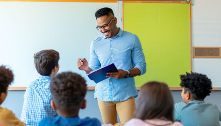 African american teacher standing in front of students in classroom at schoolの素材