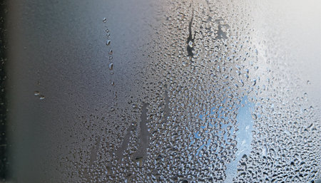 Water drops on the glass. Close-up of condensation on the window.の素材