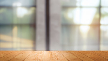 Wooden table top on blurred interior background. Mock up for display of product.の素材