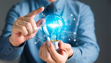 Businessman on blurred background holding and touching a lightbulb 3D renderingの素材