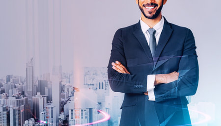 Cropped image of smiling businessman with crossed arms standing over city background with double exposure of graphs. Toned imageの素材