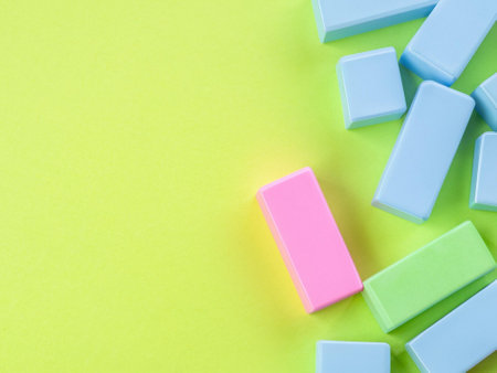 Colorful erasers on green background. Copy space for text.の素材