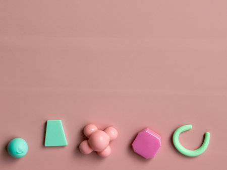 Colorful plastic toys on pink background. Flat lay, top view.の素材