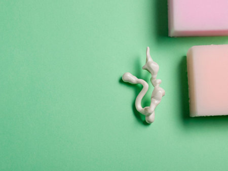 top view of soap and jelly candies on green background with copy spaceの素材