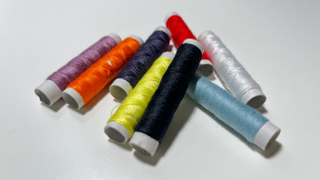colorful thread spools on white background, closeup of photoの写真素材