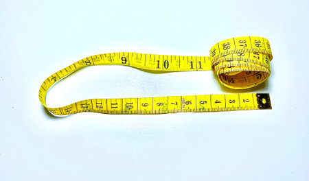 Measuring tape on a white background. The concept of weight loss.の写真素材